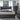 Modern bedroom set with gray furniture, including bed, dresser, storage chest and nightstands.
