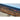 Wooden Bed surface with LED strip lighting and a smartphone charging cable.
